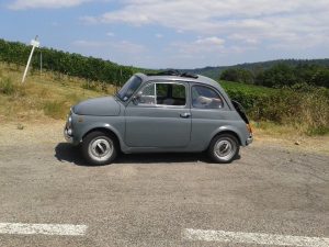 Cinquecento car on Tuscan hills